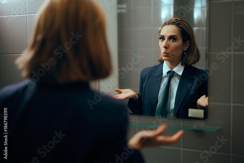 Tablou pe pânză Funny Businesswoman Checking herself in the Mirror Practicing