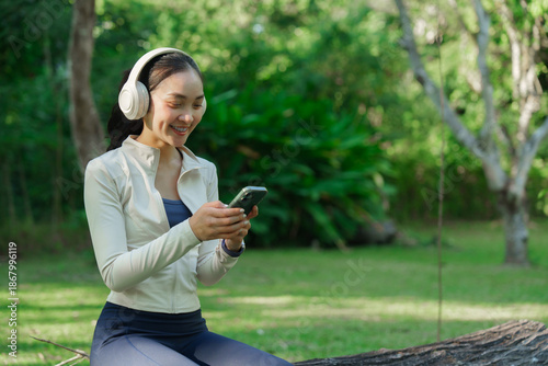 Woman enjoying music using phone in park