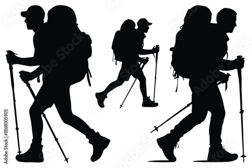 Hikers with backpacks and trekking poles in silhouette