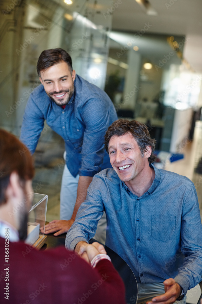 Obraz premium Meeting, happy and business people with handshake in office for teamwork, onboarding and welcome. Startup, creative agency and men shaking hands for project collaboration, partnership and agreement