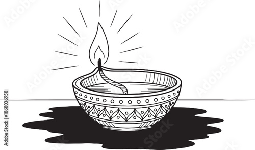 Black and white of a lit diya oil lamp flame wick light