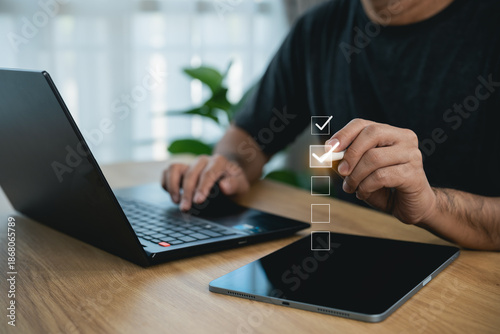 Customer hand using stylus to select 5-star rating and check boxes on laptop. Online feedback survey, business service evaluation, excellent review, and user satisfaction concept