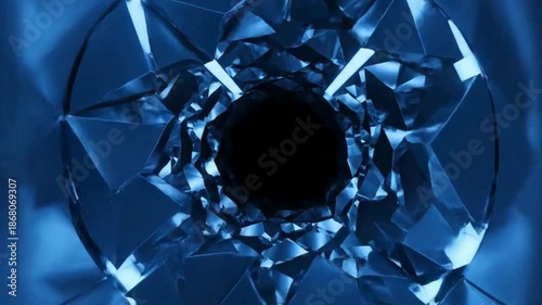 Abstract blue glass tunnel with dark center, creating a sense of depth and mystery.
