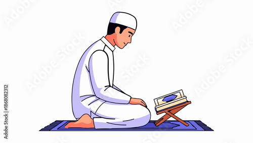 A man wearing a white cap and robe kneels on a rug, reading a book on a stand