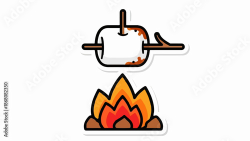 A marshmallow roasts over a campfire, lightly toasted and browned by the flames