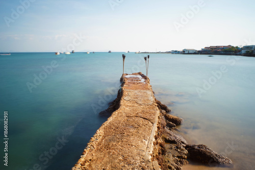 Concrete bridge walking down this path into calm sea