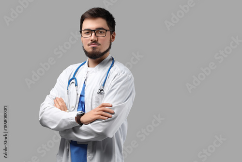 Portrait of handsome doctor in eyeglasses on light background