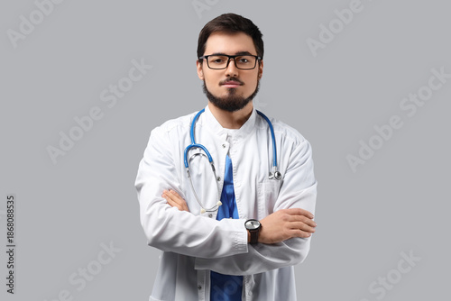 Portrait of handsome doctor in eyeglasses on light background