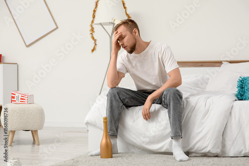 Young man with hangover and...