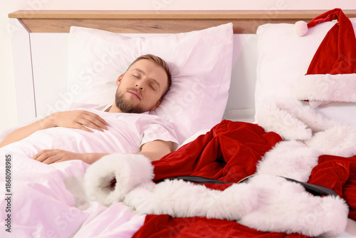 Young man with Santa costum...