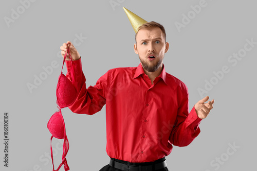 Shocked young man with bra ...