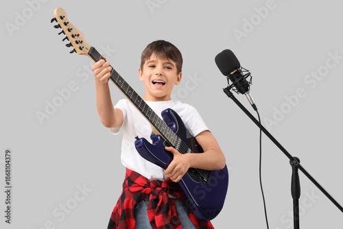 Cute boy with microphone pl...