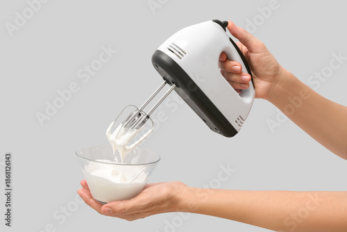 Woman using electric hand m...