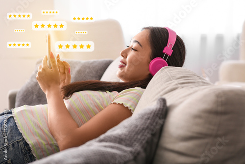 Asian woman in headphones g...