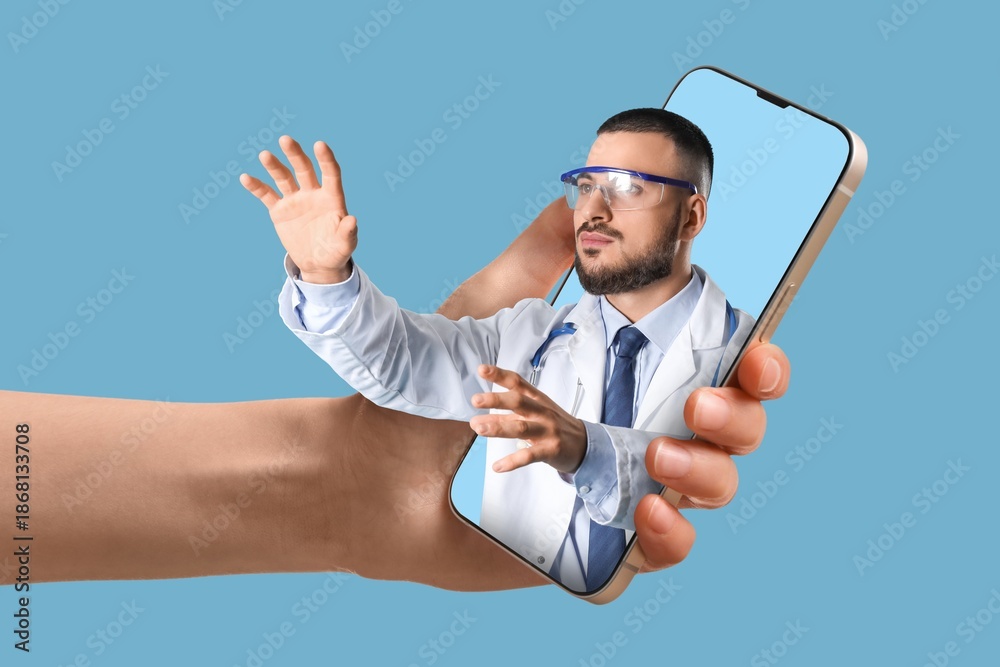 Fototapeta premium Patient holding smartphone with male doctor on screen against blue background. Concept of telemedicine