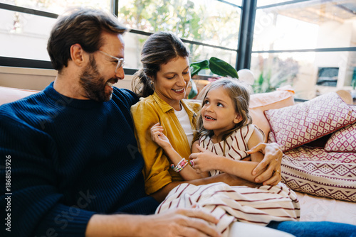 Bild auf Leinwand Family gathers on sofa, sharing smiles and warmth