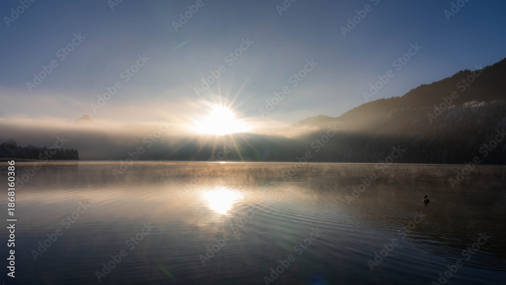 Fototapeta premium Frosty Sunrise over Weissensee in Bavaria Allgaeu Germany with great sunny Winter Vibes. High quality photo