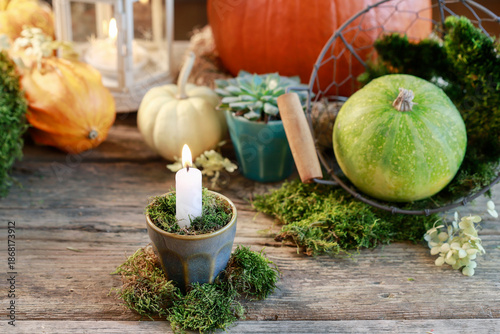 Bild auf Leinwand Classic autumn decorations with pumpkins, candles and moss on wooden table