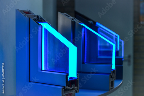 Types of plastic window profiles PVC displayed in store, with neon lighting. Selective focus.