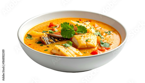 Creamy seafood soup with vegetables and herbs in a white bowl, isolated on black