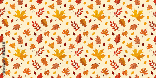 Autumn leaves in various shades of red orange and yellow on a cream background