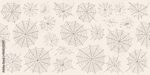 A collection of detailed spiderwebs covering a light beige background