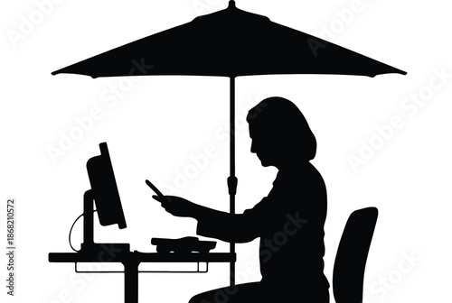 Silhouette of a person working on a laptop under an umbrella