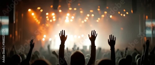 silhouettes of a dancing throng in spectacular concert lighting. notion of shared feelings and rhythmic motion