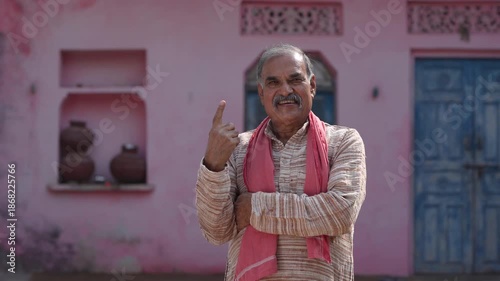 senior indian farmer showing voting sign