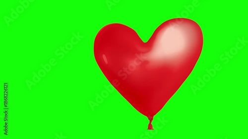 Heart balloon floating on green chroma key background