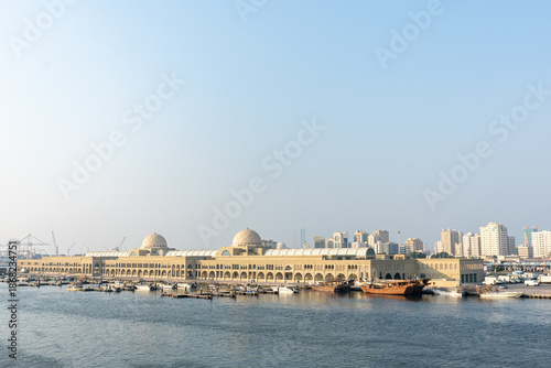 Souq Al Jubail, Sharjah, UAE,10.10.2025. Historic Market building stands along the waterfront with boats docked nearby.