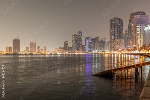 Al Majaz Waterfront promenade, Sharjah, UAE,10.10.2025. Scenic night view of city skyline along waterfront the famous busy tourist area.