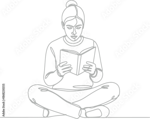 Woman sitting cross legged reading a book