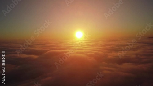 A vibrant sunrise viewed from above the clouds. Aerial view of a sunrise above the cloud layer