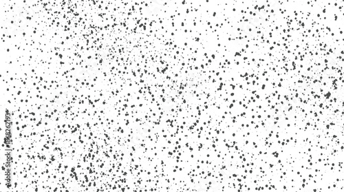 A monochromatic abstract background featuring a random scattering of dark gray dots and speckles of varying sizes on a clean white surface, creating a subtle speckled or grainy effect