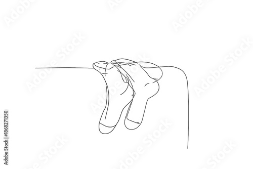 Minimalist Wool Socks. Cozy wool socks on couch. Minimalistic one-line drawing soft knitted socks draped over
