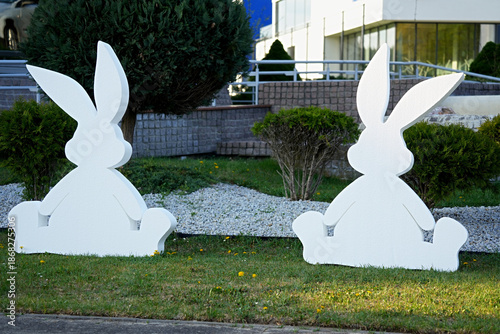 Two white decorative Easter bunnies, which are a well-known symbol of the Easter holiday.