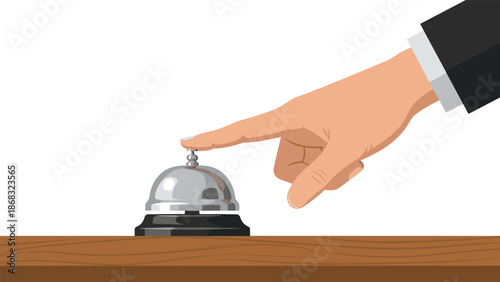 Hand pressing a silver desk bell on a wooden surface, indicating a request for service or attention, commonly found in hotels or reception areas.