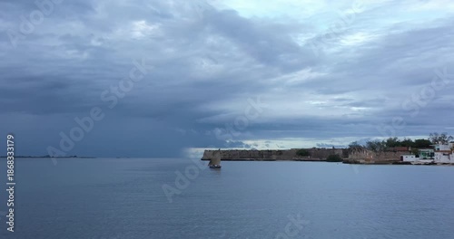 Wallpaper Mural Aerial view of a traditional sailing vessel sailing past the historic Ilha de Mocambique, under a cloudy sky, Nampula Province, Mozambique. Torontodigital.ca