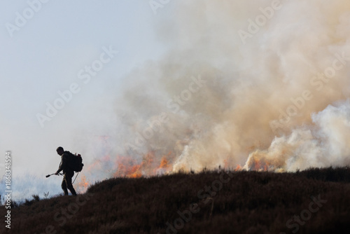 Man using a Drip Torch for controlled burning of Heather on moorland in County Durham, England, UK.