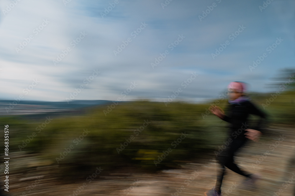 Fototapeta premium Motion Blur of Woman Trail Running