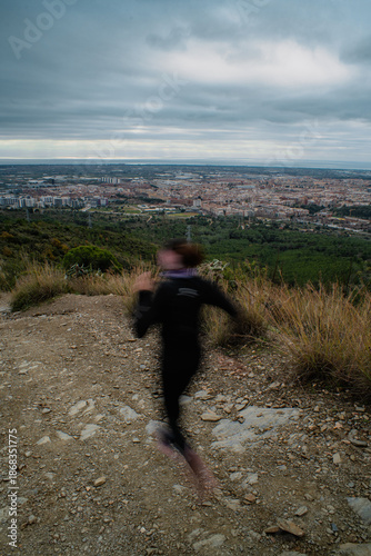 Blurred motion of a woman running outdoors in the mountains