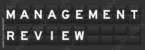 Black color analog flip board with word management review on gray background