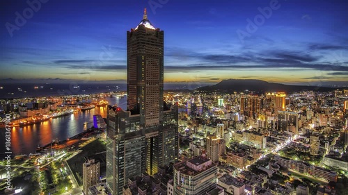 Aerial view of Kaohsiung 85 Sky Tower and Kaohsiung Harbor at sunset, Taiwan cityscape.