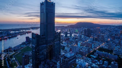 Aerial view of Kaohsiung 85 Sky Tower and Kaohsiung Harbor at sunset, Taiwan cityscape.