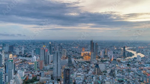Night timelapse of Chao Phraya River, Bangkok with busy ferries and vibrant city skyline.