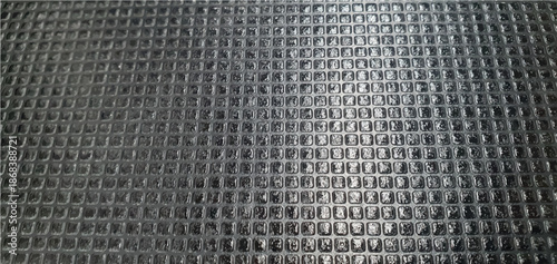 Black metal tile texture. Metal texture made of carbon tile plates on the roof exterior design. Metallic tile texture background. Construction materials. Interior design, decor.