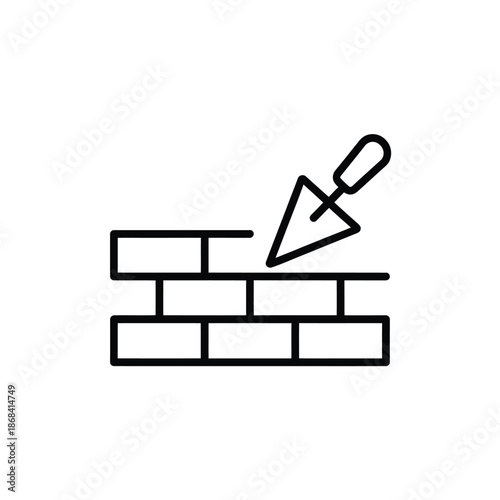 Trowel laying mortar on bricks for construction or masonry work