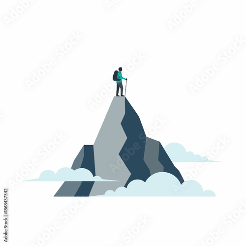 Hiker with backpack and pole standing atop a sharp rocky mountain peak above clouds