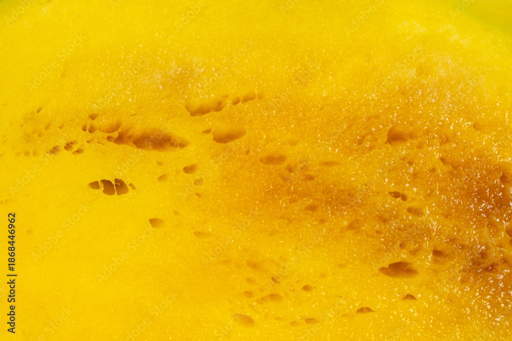 Fototapeta premium Texture of very ripe mango fruit with sweet juicy pulp. Abstract fruit background